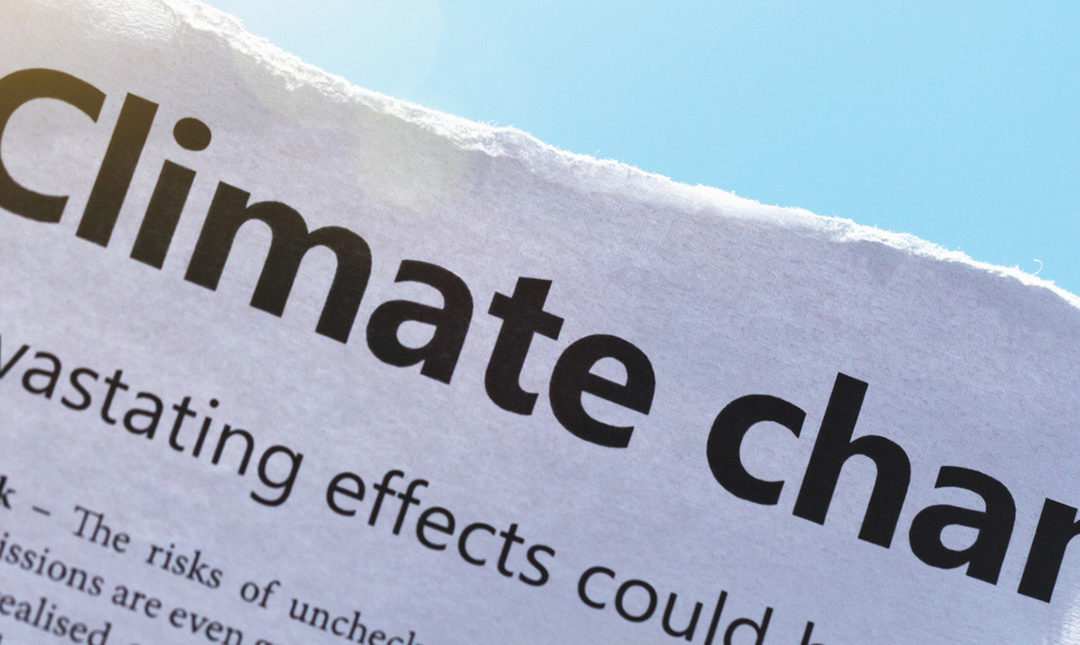 IMage of newspaper reading "Climate change"