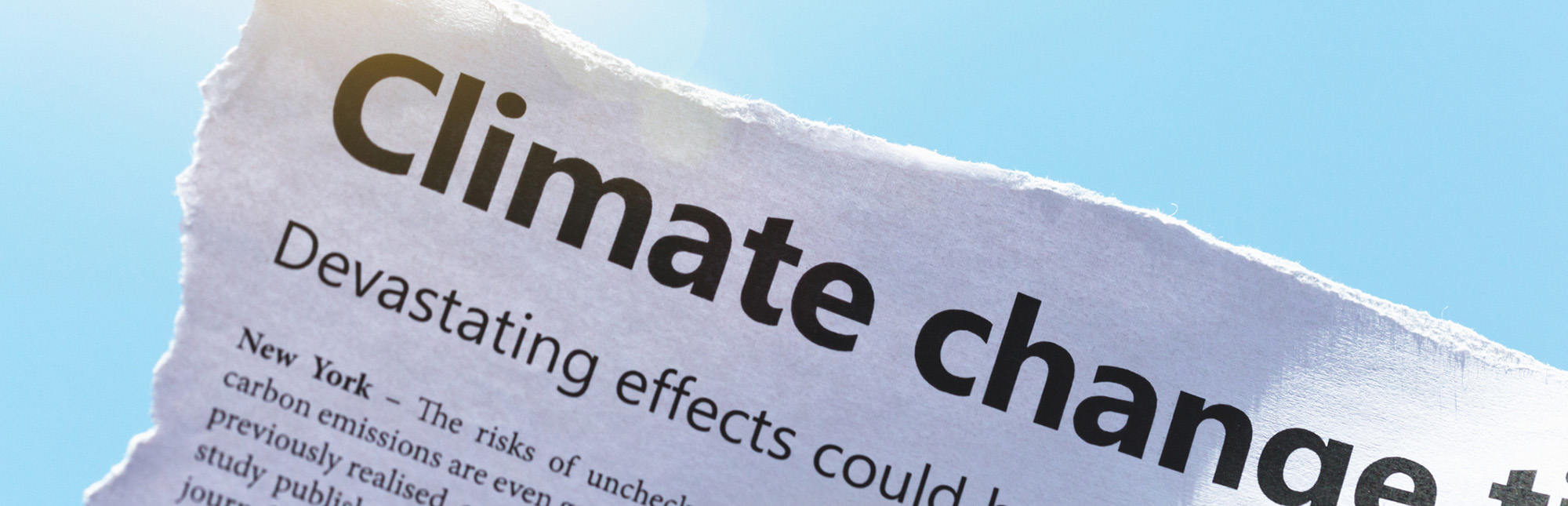 IMage of newspaper reading "Climate change"