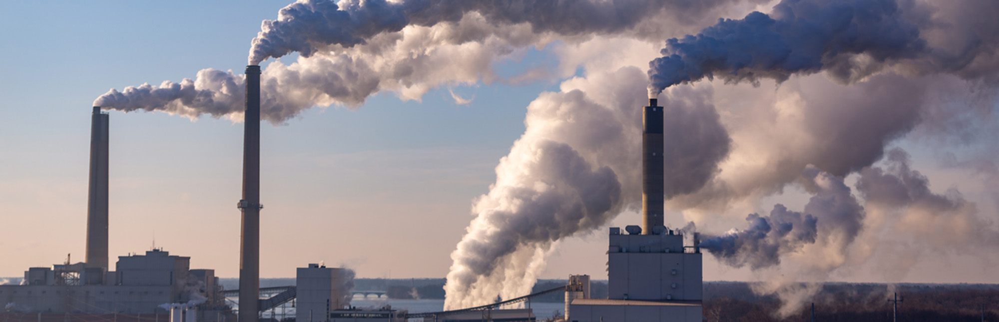 Smokestacks with billowing smoke